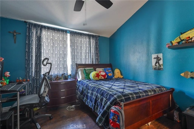 bedroom featuring lofted ceiling, a ceiling fan, and wood finished floors