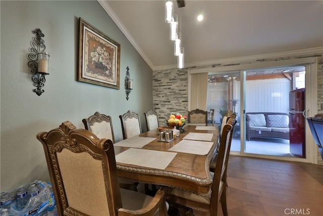 dining room featuring wood finished floors and crown molding