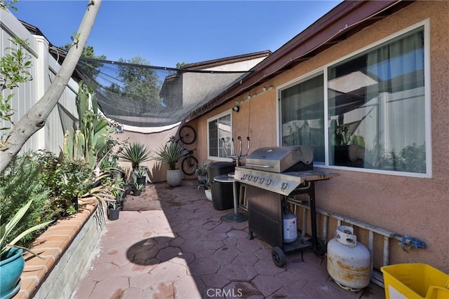 view of patio / terrace featuring a grill and fence