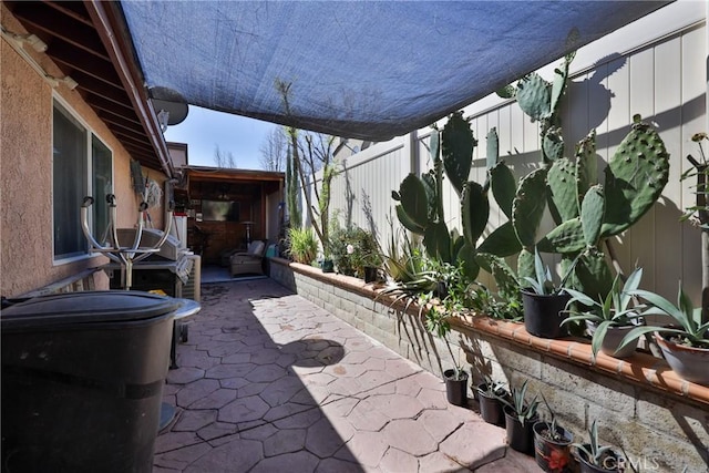 view of patio featuring fence