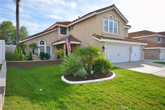 mediterranean / spanish house featuring an attached garage, stucco siding, concrete driveway, and a front yard