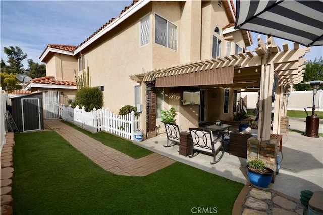 back of house featuring stucco siding, a gate, a patio area, fence, and a pergola