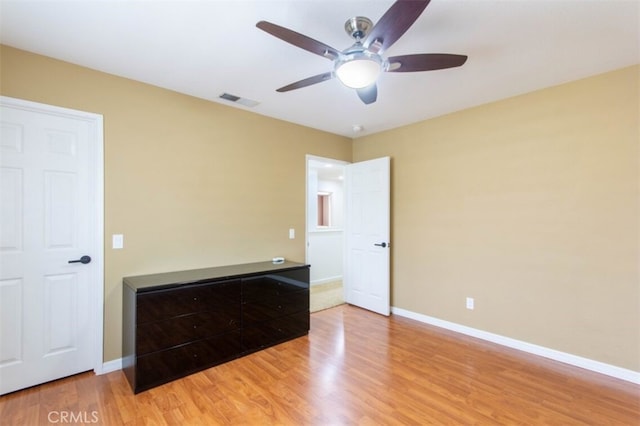 unfurnished bedroom with light wood-style floors, baseboards, visible vents, and ceiling fan