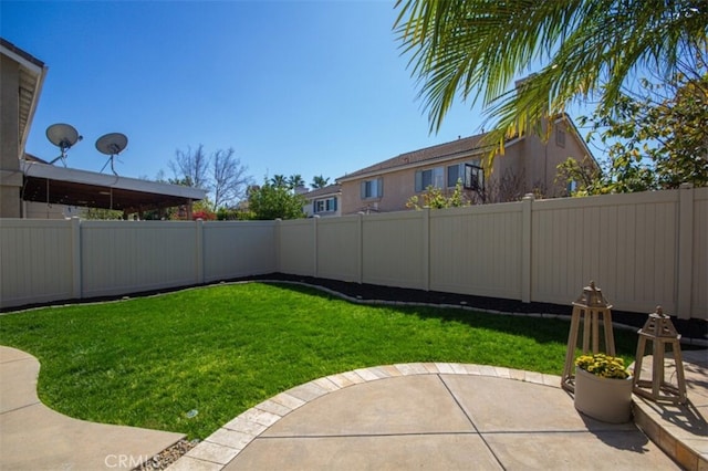 view of yard featuring a patio area and a fenced backyard