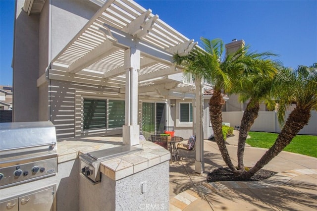 view of patio / terrace with fence, area for grilling, and a pergola