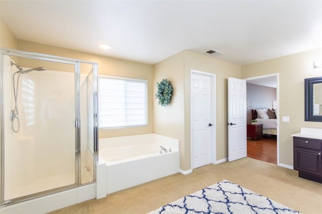 bathroom featuring a garden tub, a stall shower, vanity, and visible vents