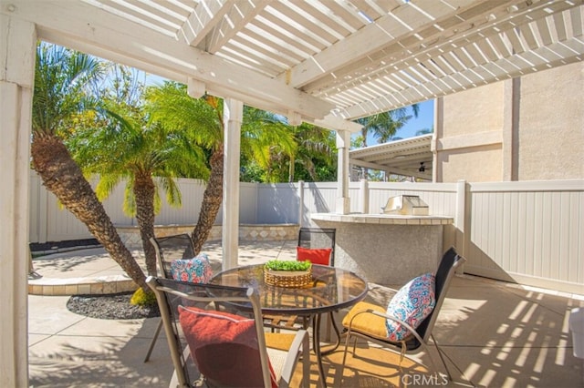 view of patio featuring a fenced backyard, outdoor dining area, and a pergola