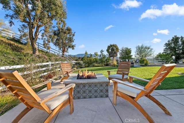 view of patio / terrace featuring an outdoor fire pit