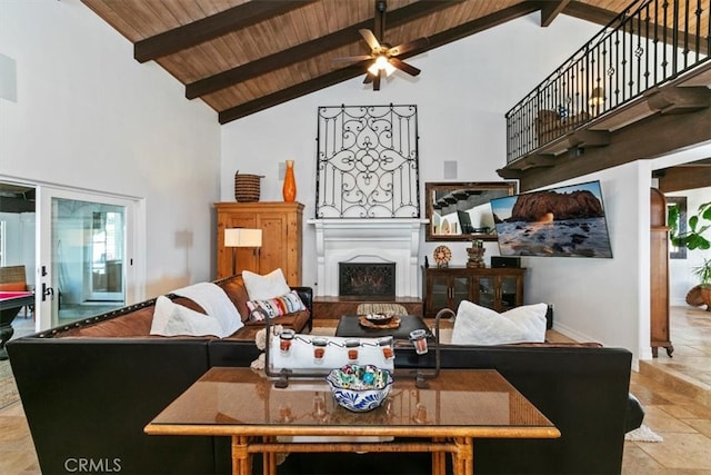 living room with beam ceiling, a fireplace, a ceiling fan, high vaulted ceiling, and wooden ceiling