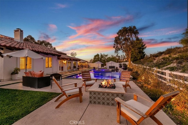 view of swimming pool featuring a fenced in pool, a patio area, an outdoor living space with a fire pit, and a fenced backyard