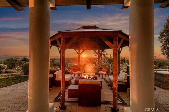 view of patio / terrace with an outdoor living space with a fire pit and a gazebo