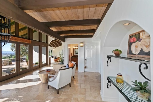 interior space with french doors, beamed ceiling, and wood ceiling