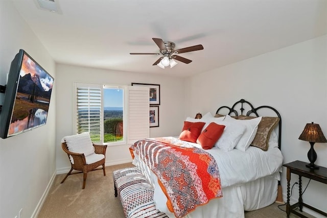 bedroom with baseboards, visible vents, a ceiling fan, and light colored carpet