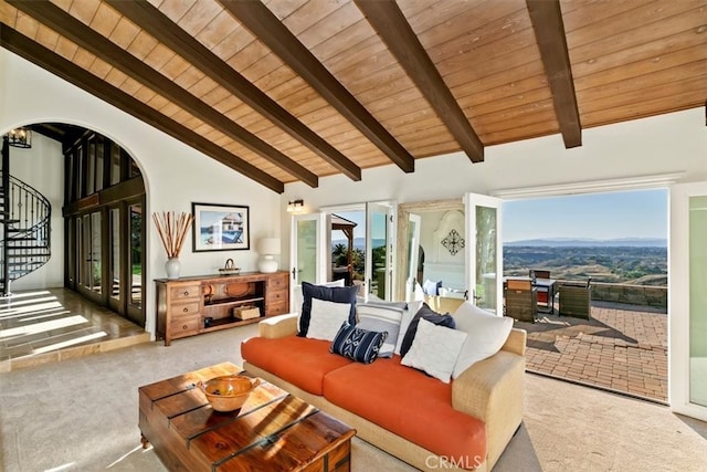 carpeted living area with arched walkways, wood ceiling, stairs, high vaulted ceiling, and beam ceiling