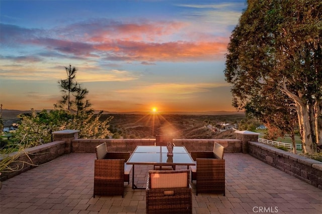 patio terrace at dusk featuring outdoor dining area