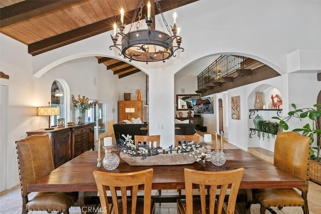 dining room featuring arched walkways, high vaulted ceiling, a notable chandelier, wood ceiling, and beamed ceiling