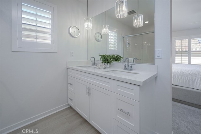 full bathroom featuring plenty of natural light, a sink, and a shower stall