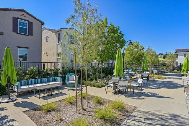 view of home's community featuring a patio area and fence