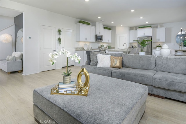 living room with recessed lighting and light wood-style floors