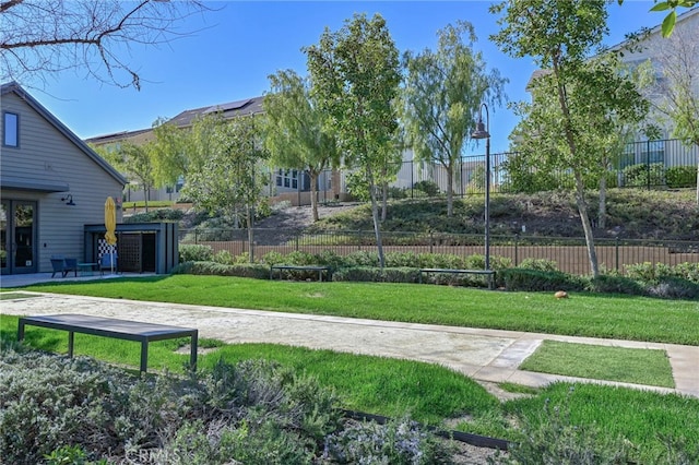 surrounding community featuring a yard and fence