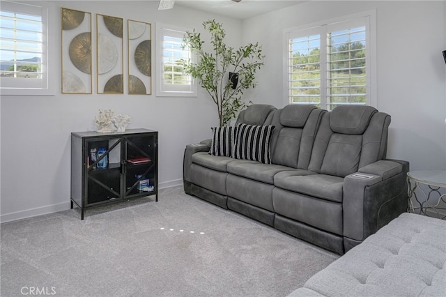 carpeted living room with a healthy amount of sunlight and baseboards