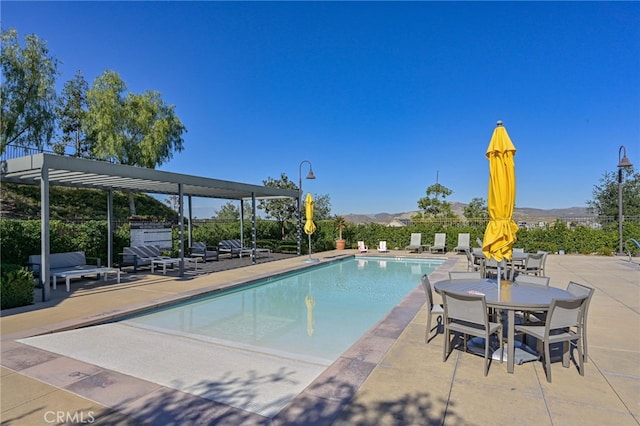 community pool featuring a patio area and fence