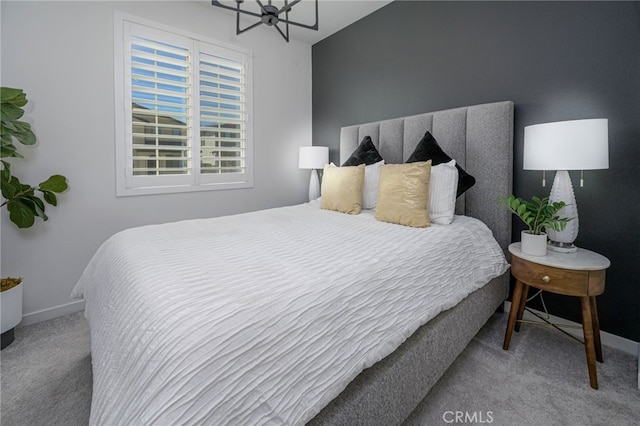 carpeted bedroom featuring baseboards