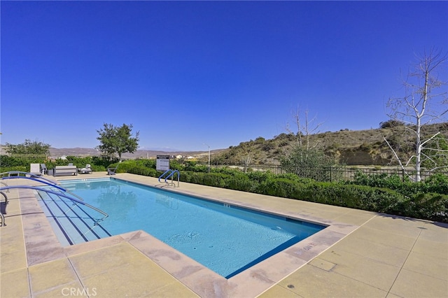 view of pool with a patio, fence, and a fenced in pool