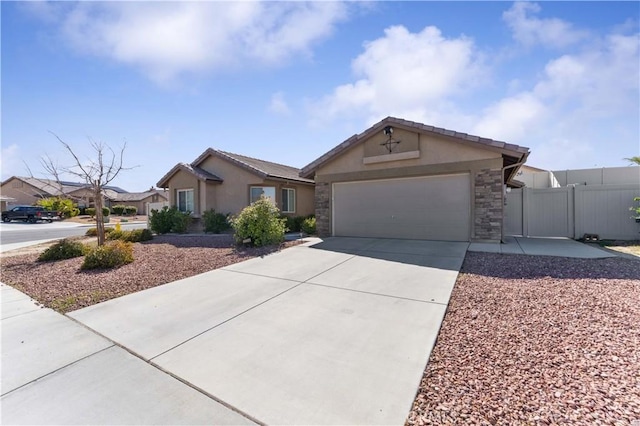 single story home with stucco siding, an attached garage, fence, stone siding, and driveway