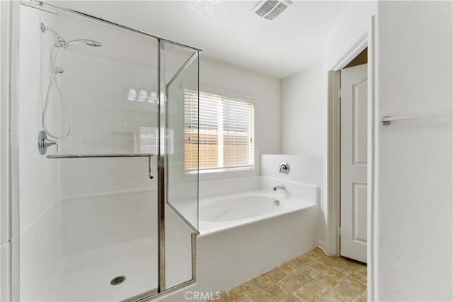 full bathroom featuring a stall shower, visible vents, and a bath