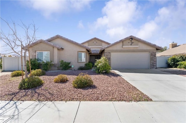 ranch-style house with a garage, concrete driveway, fence, and stucco siding