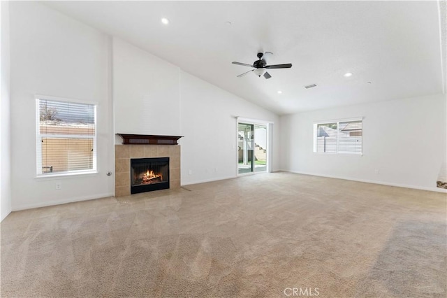 unfurnished living room featuring recessed lighting, a tiled fireplace, a ceiling fan, light carpet, and high vaulted ceiling