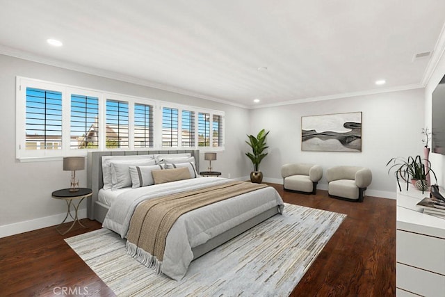 bedroom featuring crown molding, baseboards, and wood finished floors