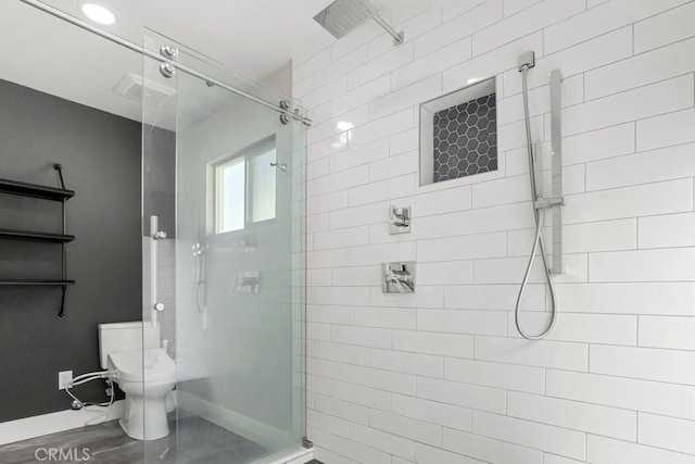 bathroom featuring visible vents, baseboards, a shower stall, and toilet