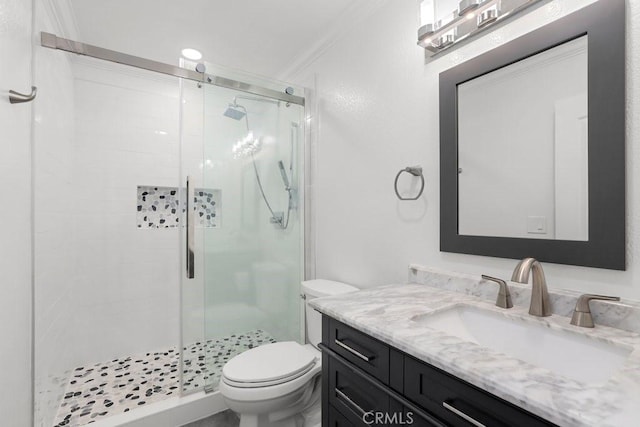 bathroom featuring a shower stall, toilet, and vanity