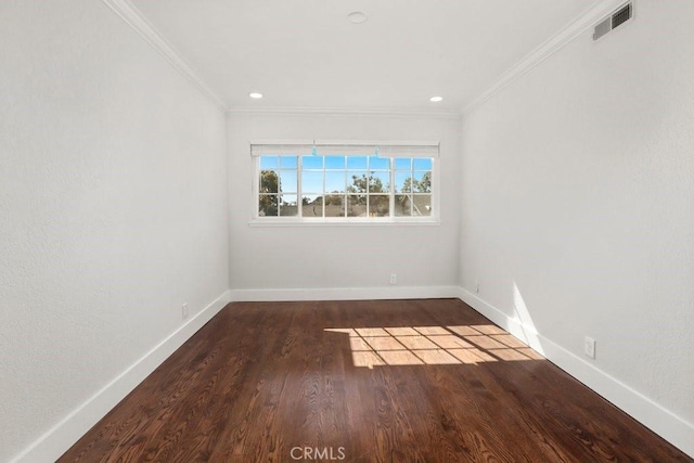 spare room featuring baseboards, visible vents, and crown molding