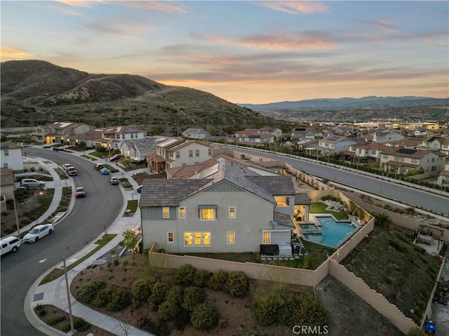 aerial view at dusk with a residential view and a mountain view