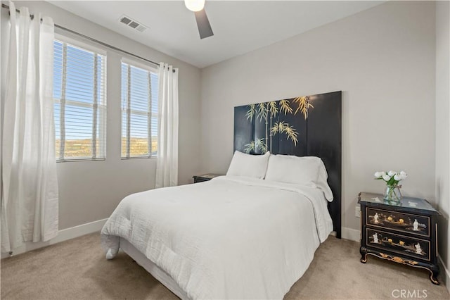 bedroom with light carpet, baseboards, visible vents, and ceiling fan