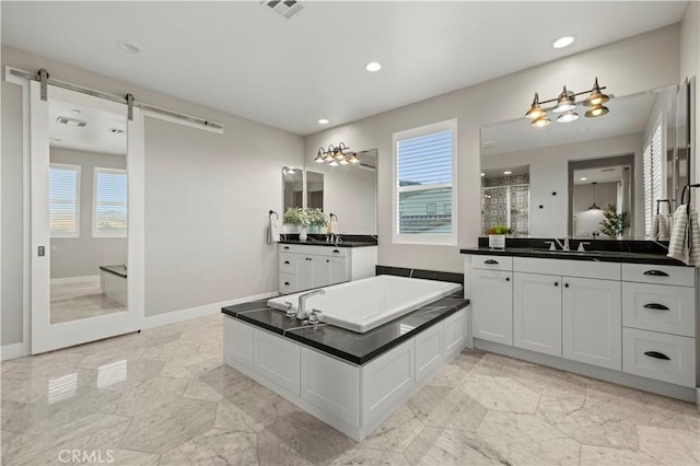 bathroom with baseboards, visible vents, a tile shower, and a garden tub