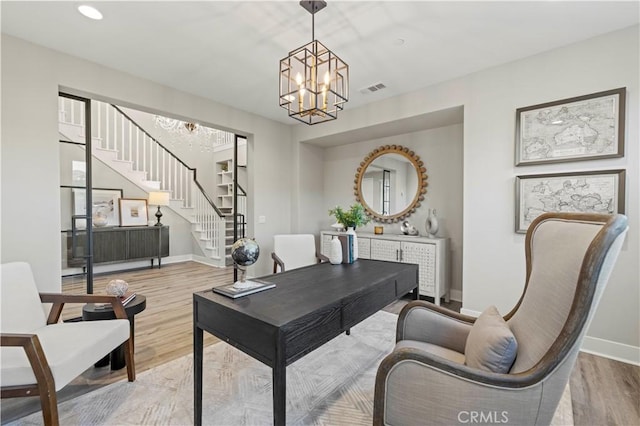 home office with a notable chandelier, recessed lighting, visible vents, wood finished floors, and baseboards