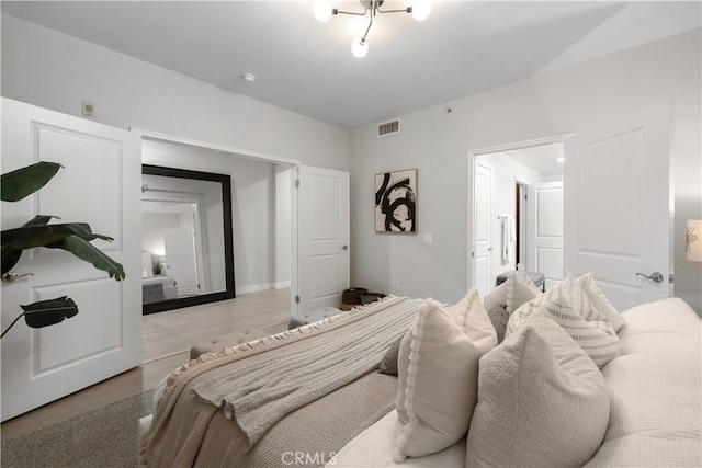 bedroom with visible vents and light wood finished floors