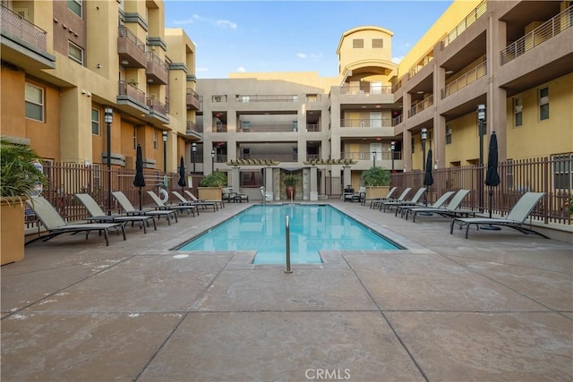 pool featuring a patio area and fence