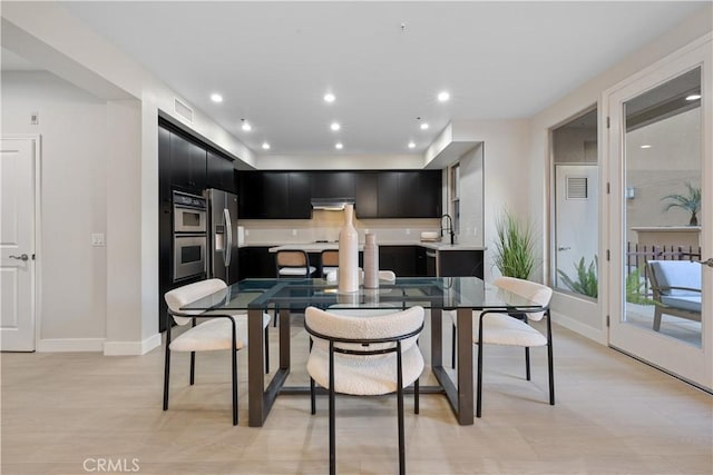 dining area with light wood-style floors, recessed lighting, visible vents, and baseboards