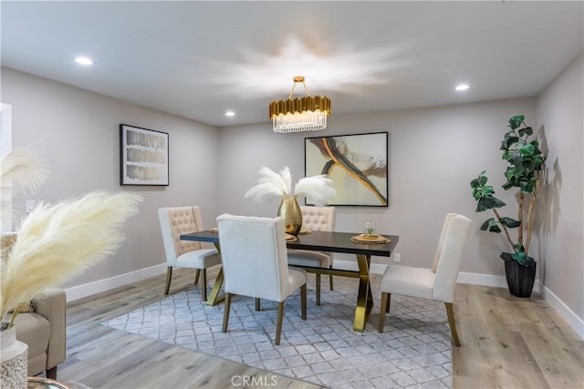 dining area with light wood-style flooring, baseboards, and recessed lighting