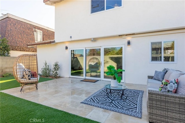 back of property with outdoor lounge area, a patio, fence, and stucco siding