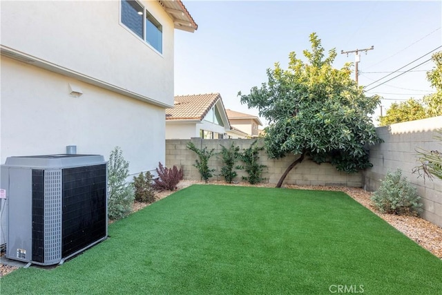 view of yard featuring a fenced backyard and central air condition unit