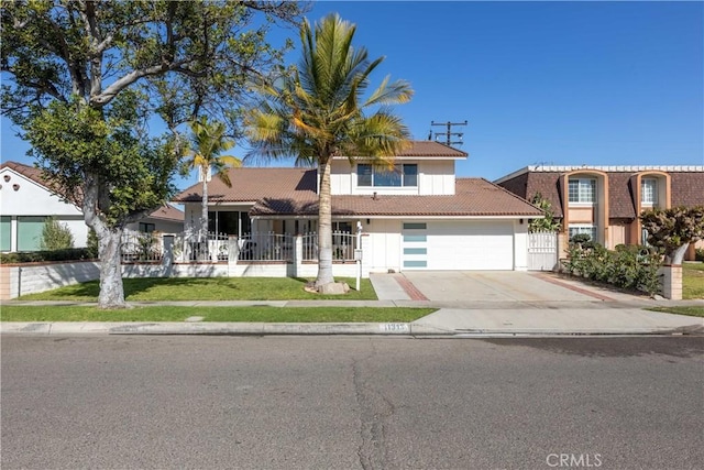 view of front of property featuring a garage, a tiled roof, concrete driveway, and fence