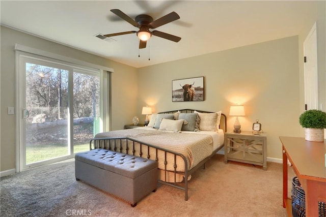 bedroom with baseboards, visible vents, and light colored carpet