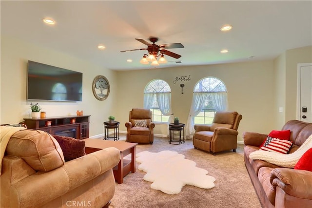 living room featuring light carpet, baseboards, a ceiling fan, and recessed lighting