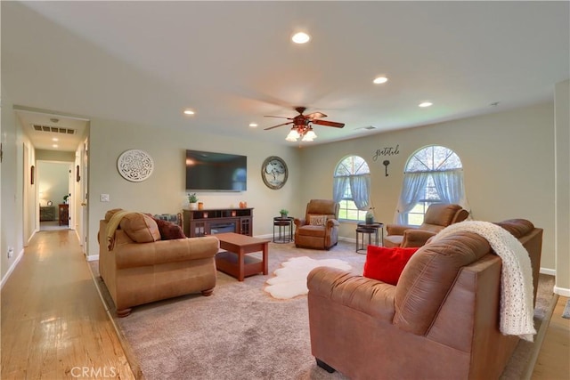 living room featuring baseboards, a ceiling fan, visible vents, and recessed lighting